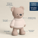 Natural rubber bear teether stands upright, designed for teething comfort with soft textures, easy to grip, and squeezable.