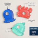 Nautical-themed teething toys featuring an octopus, crab, and sailboat, showcasing vibrant colors and textures.