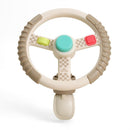 Taupe Itzy Ritzy Driver Travel Steering Wheel with colorful buttons, designed for imaginative play and travel fun.