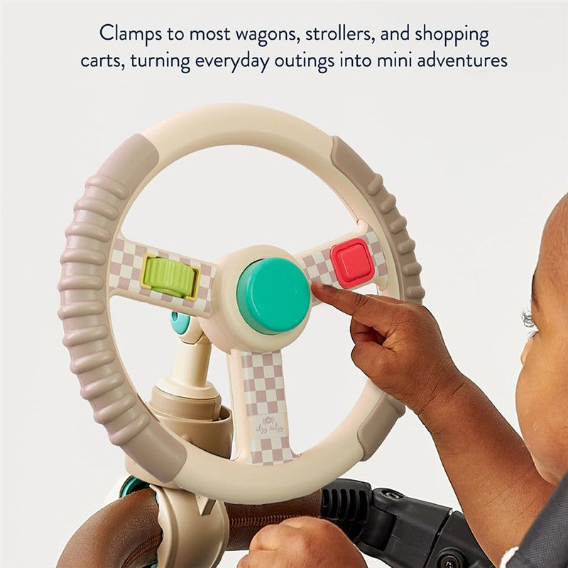 Taupe steering wheel toy with colorful buttons, designed to clamp to strollers and wagons for interactive play.