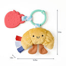 Infant teething toy featuring a soft croissant design, a strawberry-shaped teether, and colorful ribbons for sensory play.