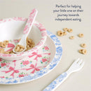 Bistro 4-piece dining set featuring a pink floral bowl, blue rimmed plate, spoon, and fork, accompanied by cereal.