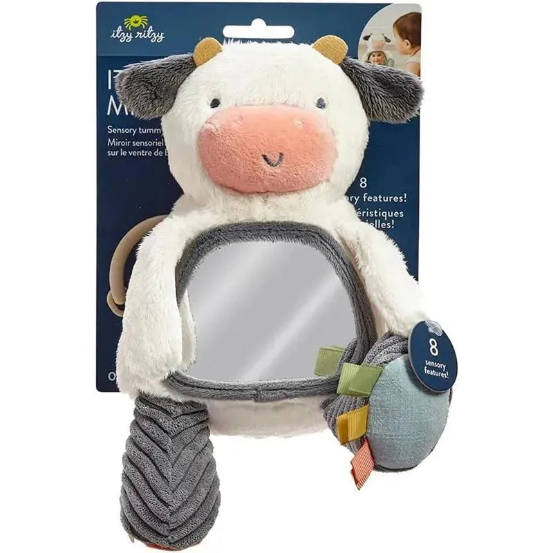 Itzy Ritzy Itzy Bitzy Mirror featuring a plush cow design with a sensory mirror and attached tags for tactile exploration.