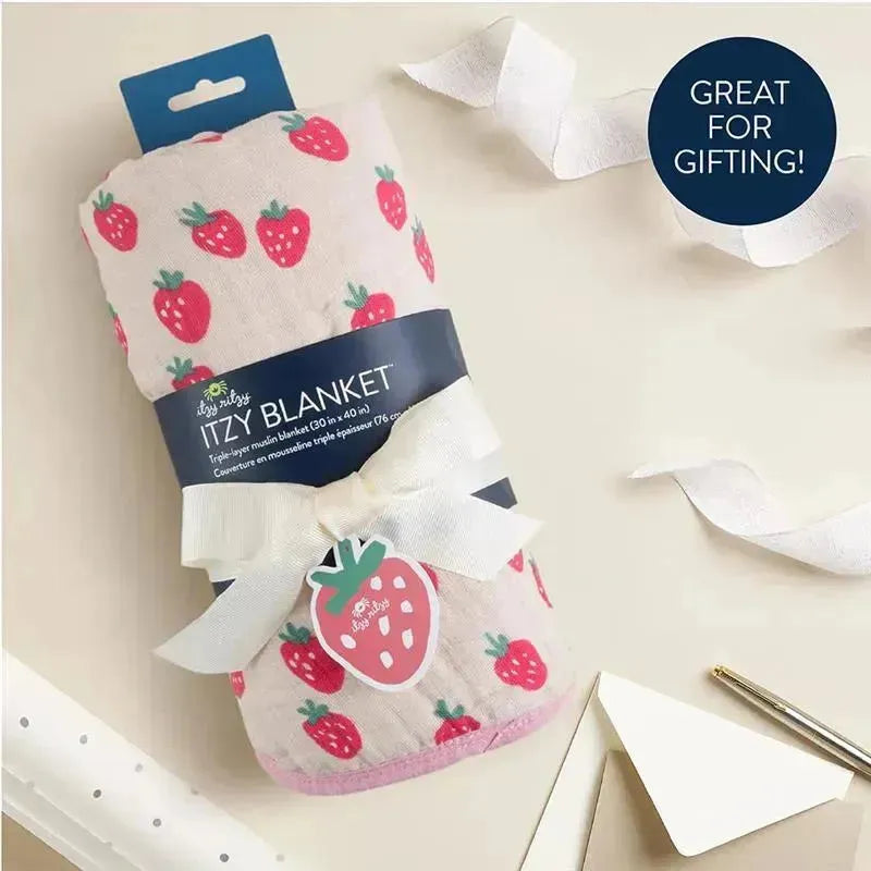 Itzy Ritzy Itzy Blanket™ in Strawberries + Cream design, featuring a triple-layer muslin fabric, rolled with a ribbon and gift tag.