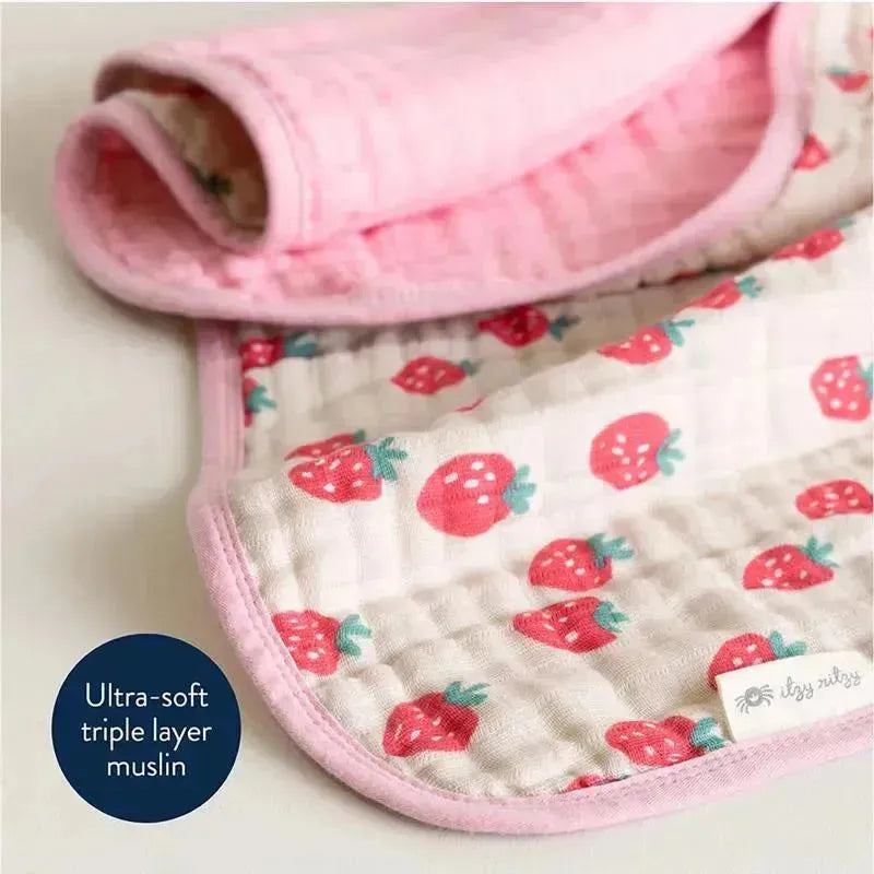 Ultra-soft Itzy Blanket™ in Strawberries + Cream design, featuring a pink border and strawberry pattern on muslin fabric.