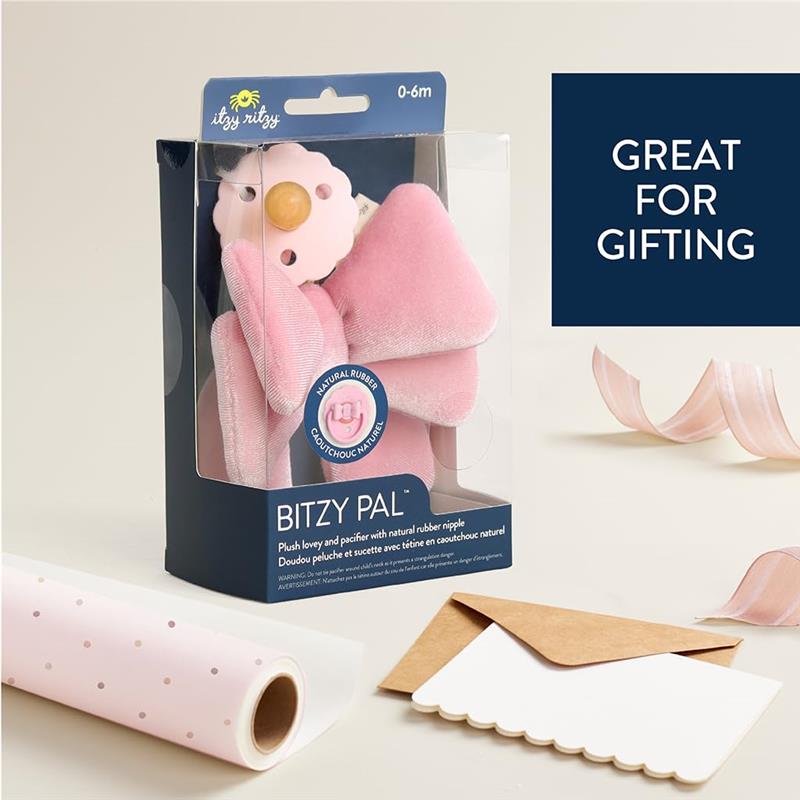 Plush Itzy Ritzy Bitzy Pal toy and pacifier packaged for infants 0-6 months, featuring a natural rubber nipple and pink design.