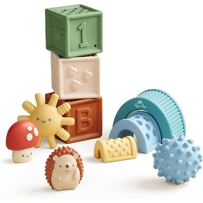 Colorful Itzy Ritzy Itzy Blocks™ set featuring stacking blocks, a hedgehog, a sun, and textured toys for sensory play.