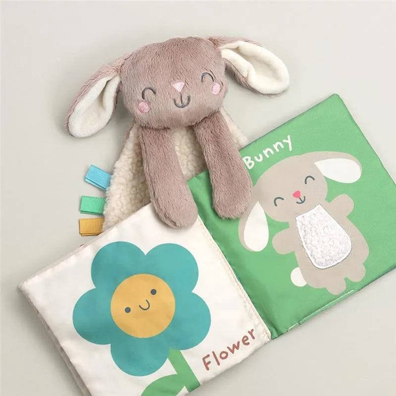 Itzy Ritzy Learn & Snuggle Gift Set featuring a plush bunny head and soft fabric pages with a smiling flower and bunny character.