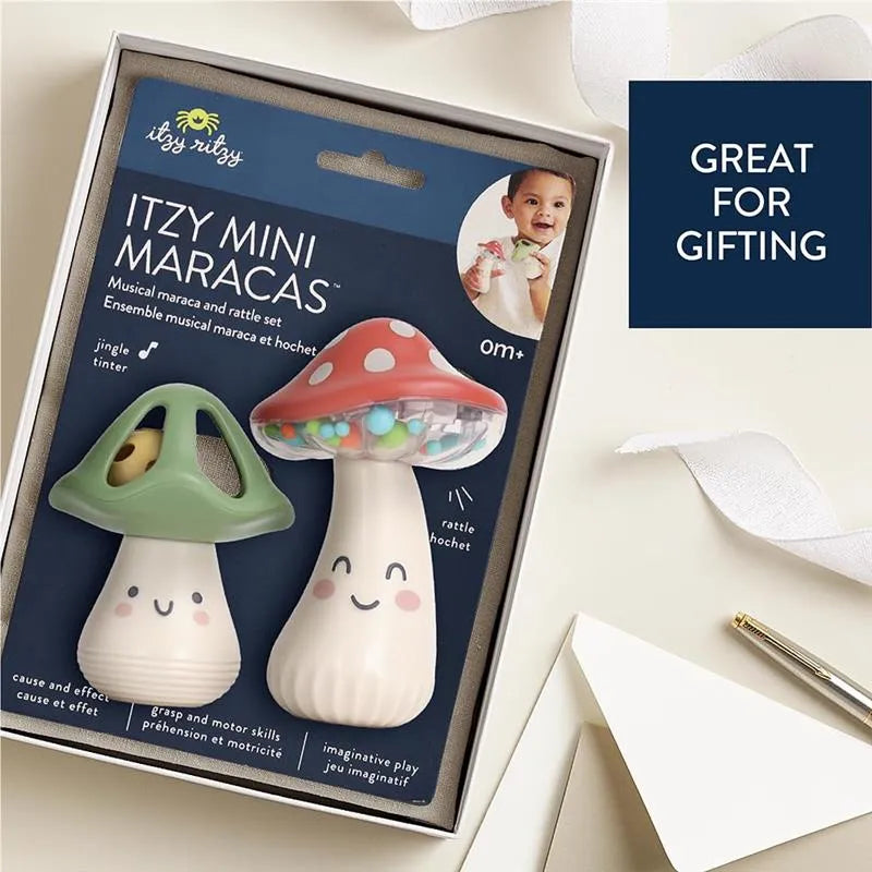 Itzy Mini Maracas musical set featuring a green mushroom rattle and a red mushroom maraca with playful designs.