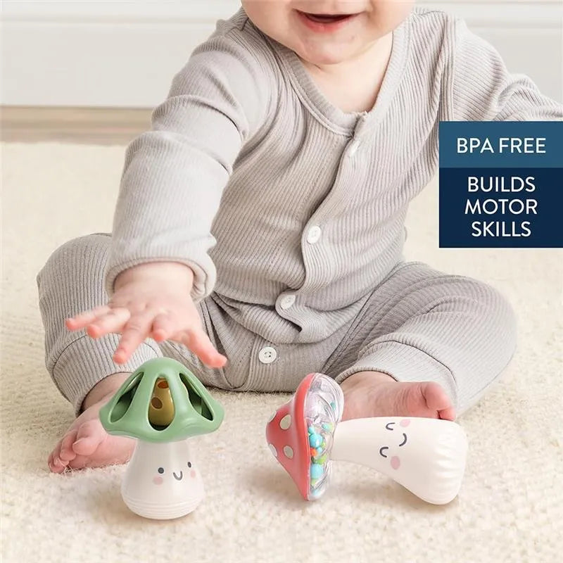 Baby reaching for Itzy Ritzy Mini Maracas, colorful mushroom-shaped toys that build motor skills and are BPA free.
