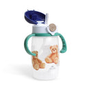 Itzy Ritzy straw cup with snap-close lid features a transparent body adorned with teddy bear designs and green handles.