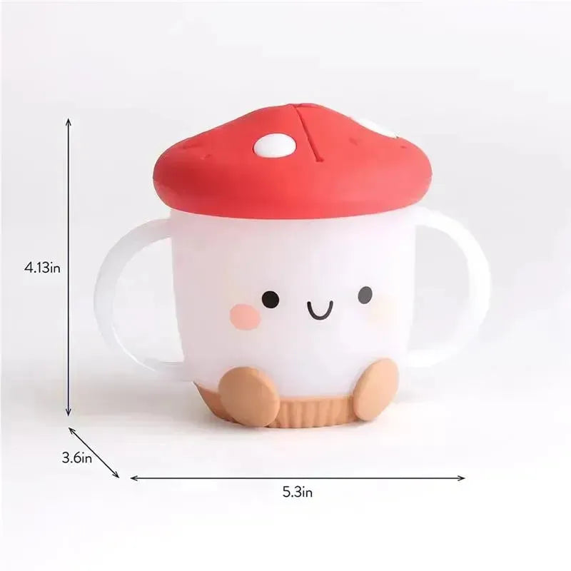 Itzy Ritzy Itzy Snack Cup in mushroom design, featuring a smiling face, red cap, and white body with handles.