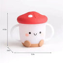 Itzy Ritzy Itzy Snack Cup in mushroom design, featuring a smiling face, red cap, and white body with handles.