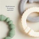 Linkable teething ring set featuring a gray elephant-shaped ring, a twisted ivory ring, and a green textured ring.