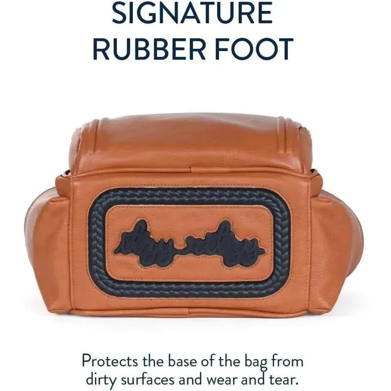 Cognac Itzy Ritzy Mini Plus Diaper Bag featuring a rubber foot base for protection against wear and tear.