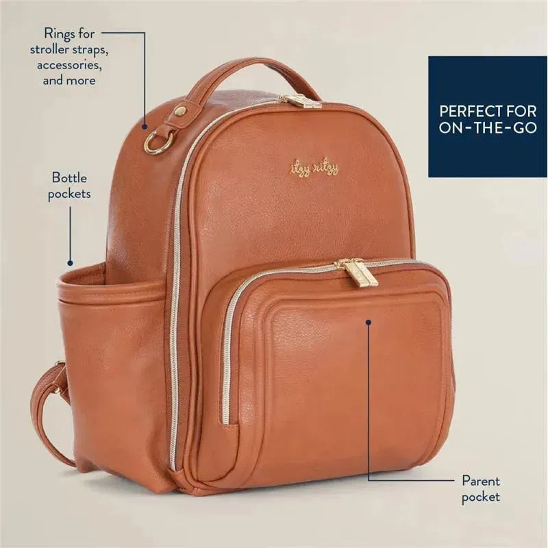 Mini Plus Diaper Bag by Itzy Ritzy in cognac, featuring zippers, bottle pockets, and rings for stroller straps.