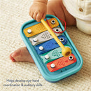 Itzy Ritzy Music School Xylophone, featuring colorful keys shaped like fish, being played by a toddler with a yellow mallet.