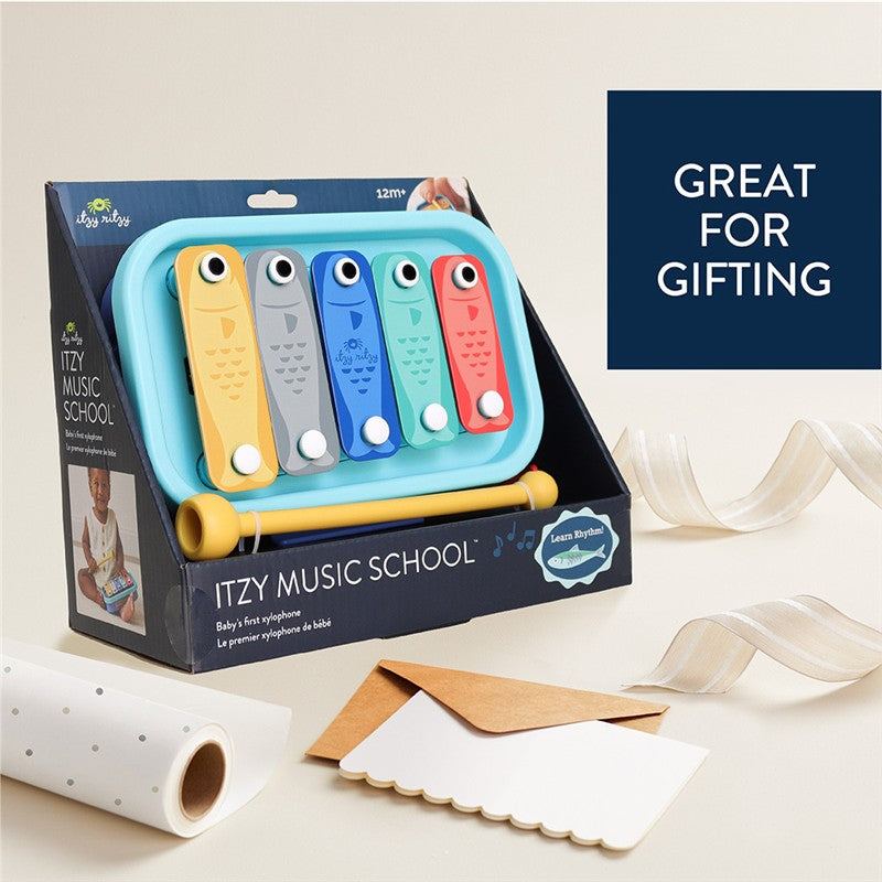Itzy Ritzy Music School xylophone for babies featuring five colorful keys, suitable for ages 12 months and up, in gift packaging.