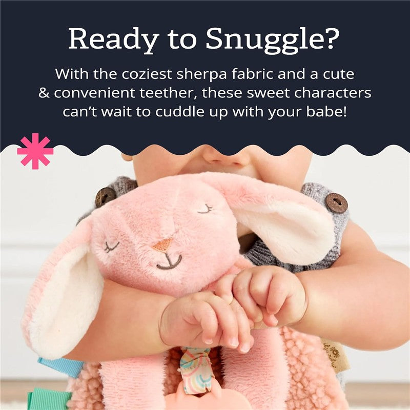Itzy Ritzy Pink Bunny Lovey with Teether, featuring soft sherpa fabric, held by a baby, promoting snuggling and comfort.