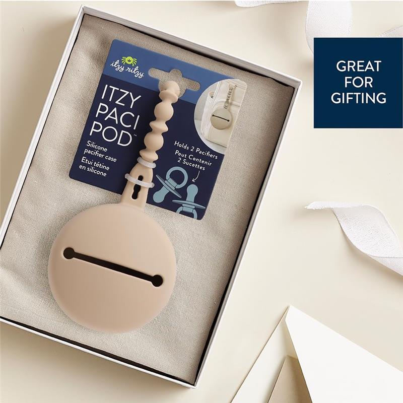 Silicone pacifier case by Itzy Ritzy, designed to hold two pacifiers, in a light toast color, with packaging indicating gifting suitability.