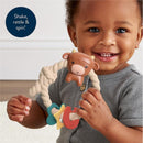 Silicone teether featuring a brown Highland cow head, held by a smiling child, with colorful attachments for sensory play.