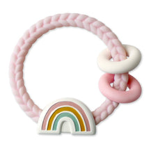 Silicone teether with a pink braided design, featuring a rainbow with pastel colors and two accompanying rings.