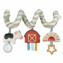 Spiral car seat activity toy featuring a plush cow, barn, sun, mirror, and colorful ribbon tags for sensory play.