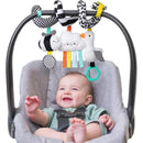 Baby smiling in a stroller with Itzy Ritzy Spiral Car Seat & Stroller Activity Toy featuring plush animals, a mirror, and colorful ribbons.