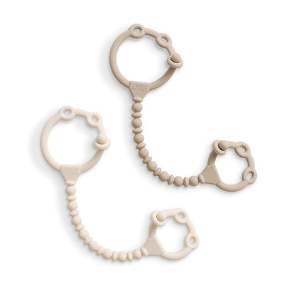 Silicone toy and snack cup straps in toast and buttercream colors, featuring textured and smooth designs.
