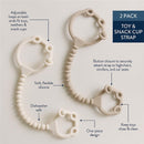 Two silicone toy and snack cup straps in soft beige, featuring adjustable loops and button closure for secure attachment.