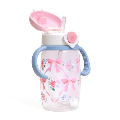 Straw sippy cup featuring a pink lid, blue handles, and a floral design with ribbons and roses.