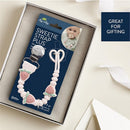 Strawberry silicone pacifier clip by Itzy Ritzy, featuring a heart-shaped clip and a packaging designed for gifting.