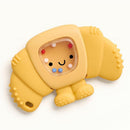 Yellow croissant-shaped teething and rattle toy featuring a smiling face and colorful beads inside for added engagement.