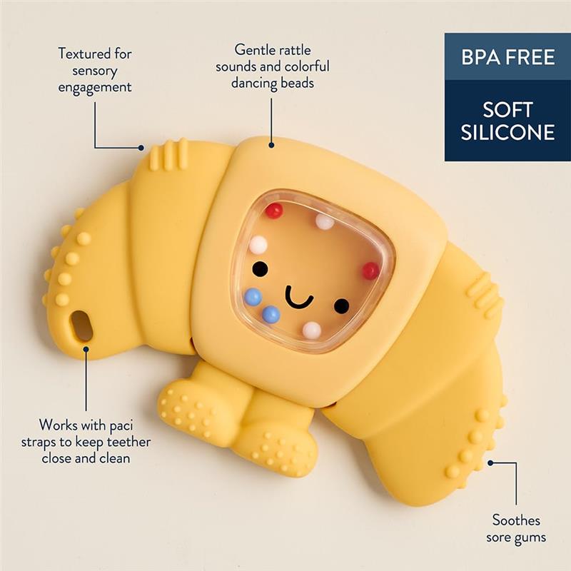 Croissant-shaped teething and rattle toy with textured silicone, colorful beads, and BPA-free material for soothing gums.