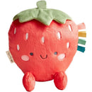 Plush strawberry toy with a smiling face, green leaves, and colorful ribbon tags, perfect for cuddling.