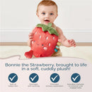 Baby holds a plush strawberry character named Bonnie, promoting sensory exploration and self-soothing.