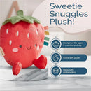 Sweetie Snuggles Plush is a soft strawberry-shaped toy with blushing cheeks and colorful tags, designed for babies.