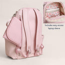 Pink backpack diaper bag with floral interior, featuring easy access laptop sleeve and adjustable straps.