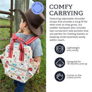 Toddler wearing a Itzy Ritzy Farm Friends backpack with adjustable straps, standing outdoors near a fence.