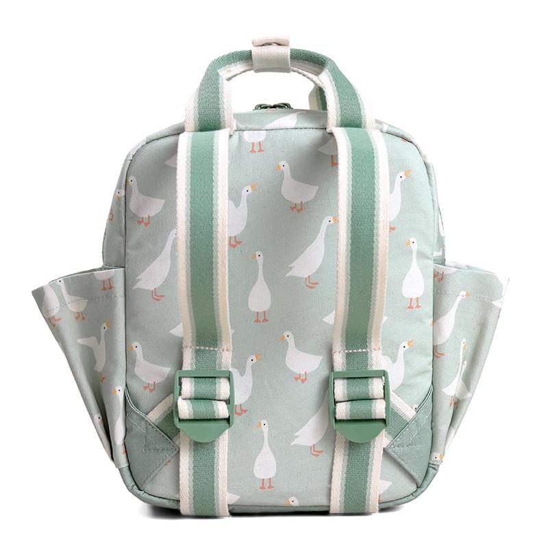 Green toddler backpack with white goose patterns, featuring adjustable straps and a top handle.