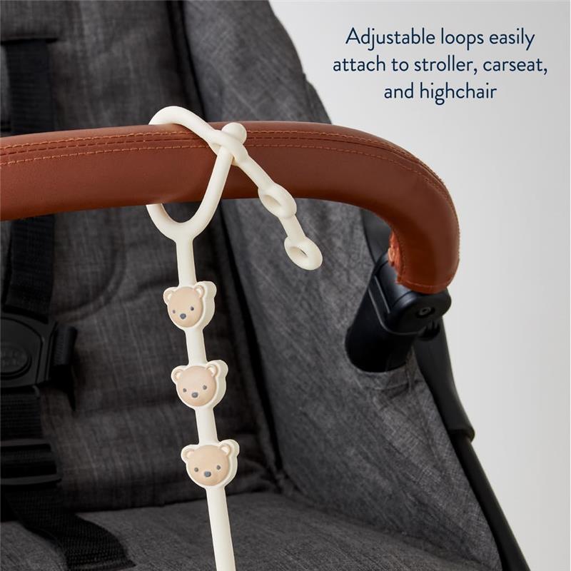 Toy and snack cup strap featuring adjustable loops and teddy bear details, designed to attach to strollers and highchairs.