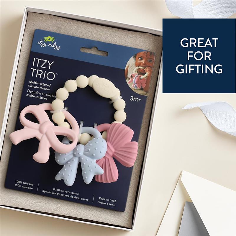 Multi-textured silicone teether bows in pink and blue, packaged for gifting, suitable for infants 3 months and older.