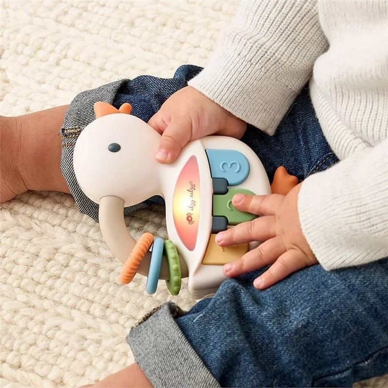 Interactive piano toy in the shape of a goose, being played by a child with colorful keys and rings.