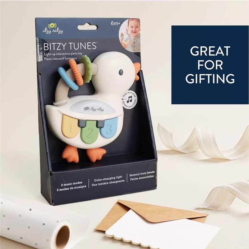 Light-up interactive piano toy shaped like a goose, featuring colorful keys and sensory beads, suitable for ages 6 months and up.