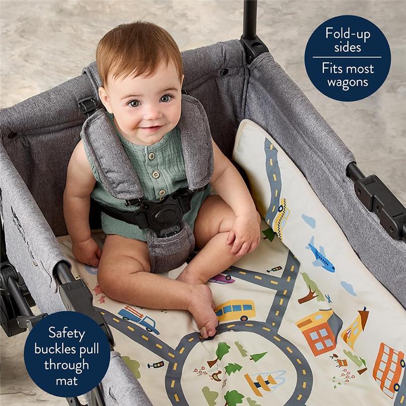 Two-in-one play mat with town scene and taupe checkerboard, featuring a seated baby in a wagon with safety buckles.