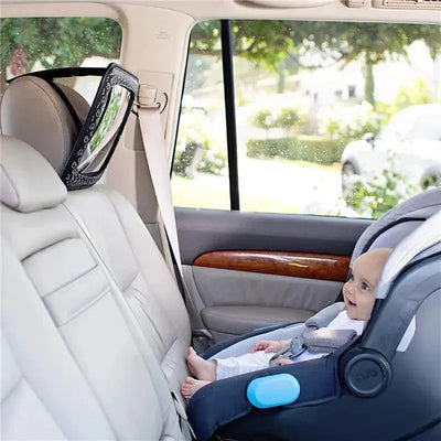 Adjustable car mirror featuring Mickey Mouse, positioned to reflect a smiling baby in a car seat.