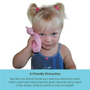 A child with blonde hair and pigtails holds a pink Boo Boo Zoo ice pack against her cheek, looking comforted.