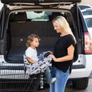Shopping cart cover featuring a Batman design, with a child seated, as a woman prepares to shop.