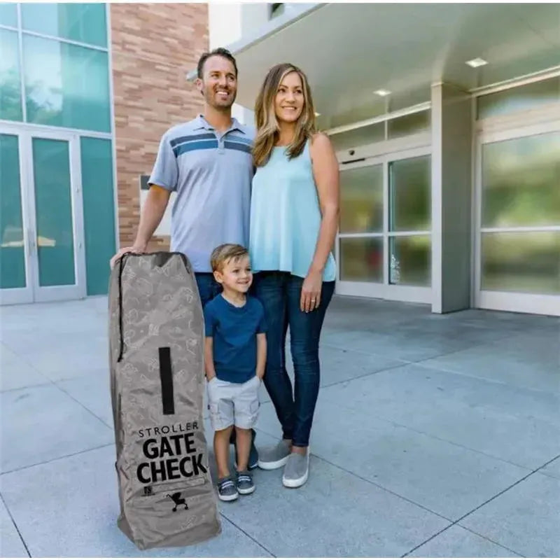 Deluxe Gate Check Travel Bag for Umbrella Strollers displayed beside a family at an airport entrance.