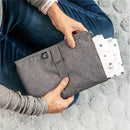 Extra-large grey J.L. Childress baby changing pad bundle held by a person, with a floral-patterned pad peeking out.